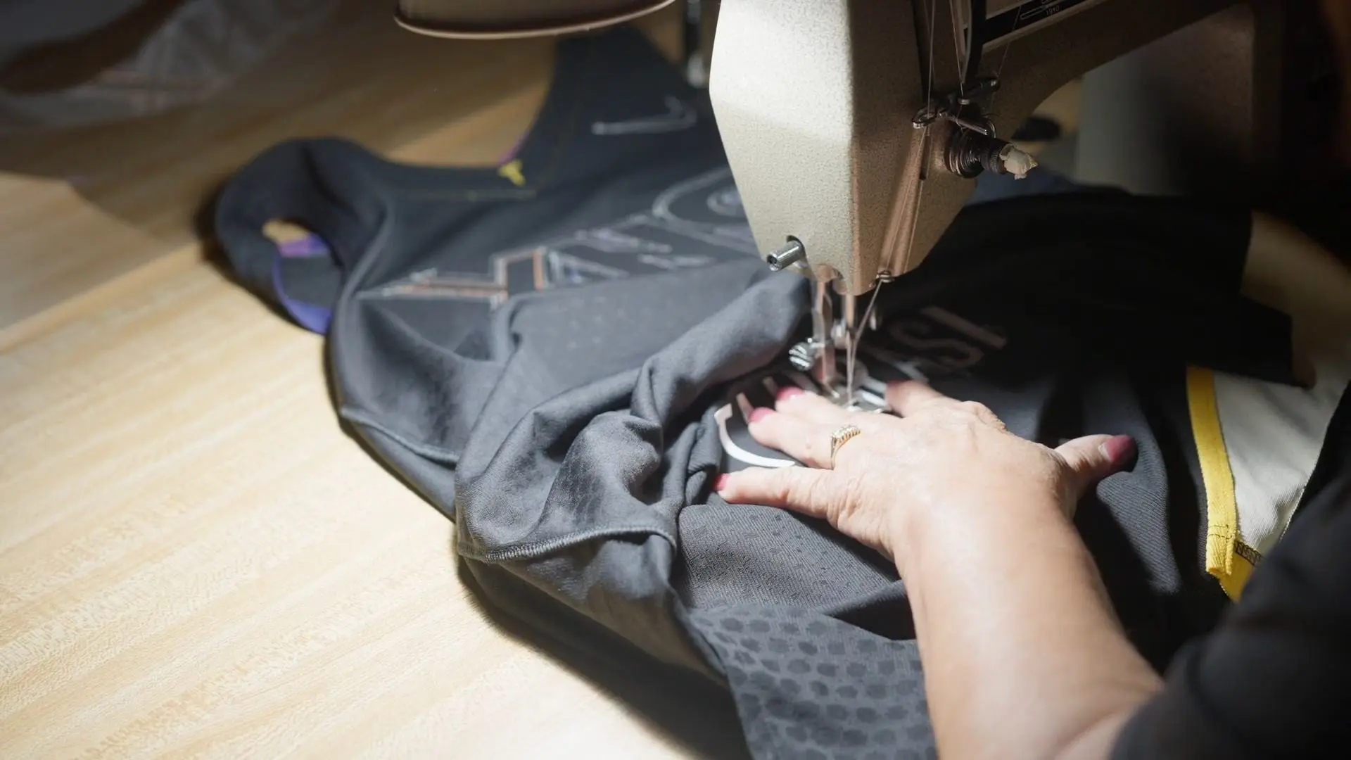 A person sewing something on the table