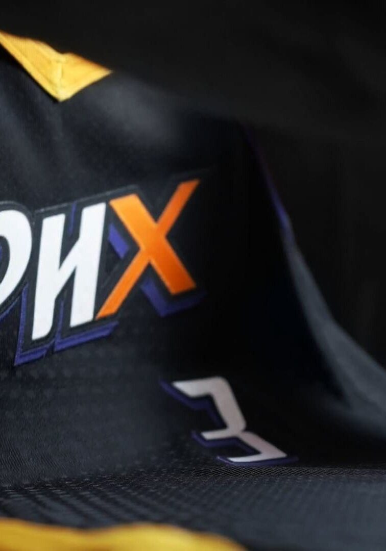 A close up of the phx logo on a shirt.