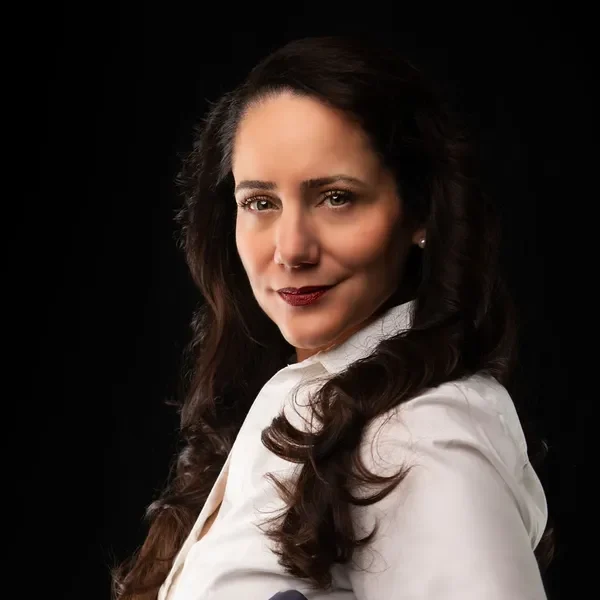 A woman with long hair and a white shirt